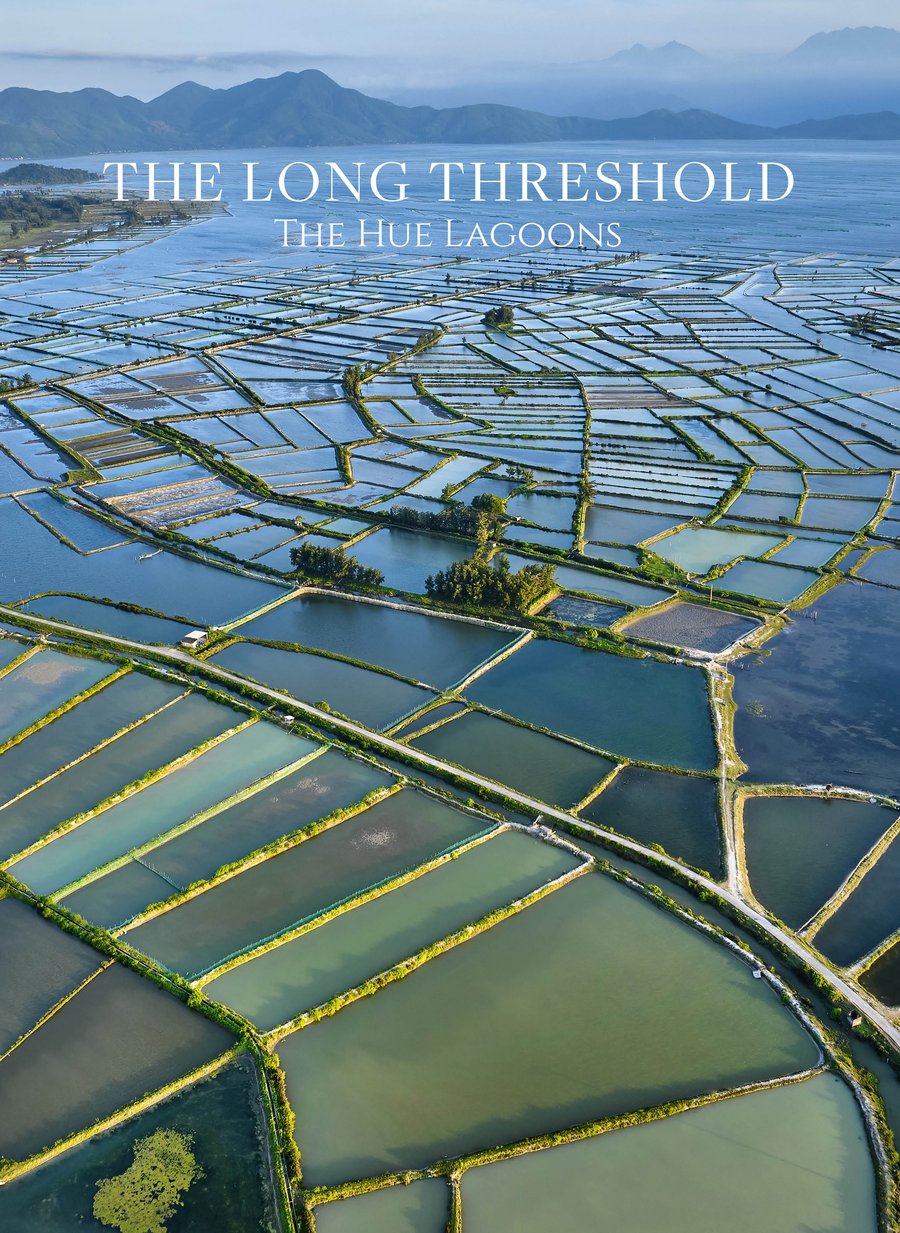 Cover of The Long Threshold: an aerial view of aquaculture ponds on the Hue lagoon, mountains behind.
